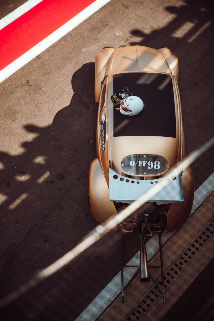 A gold car is parked on the track